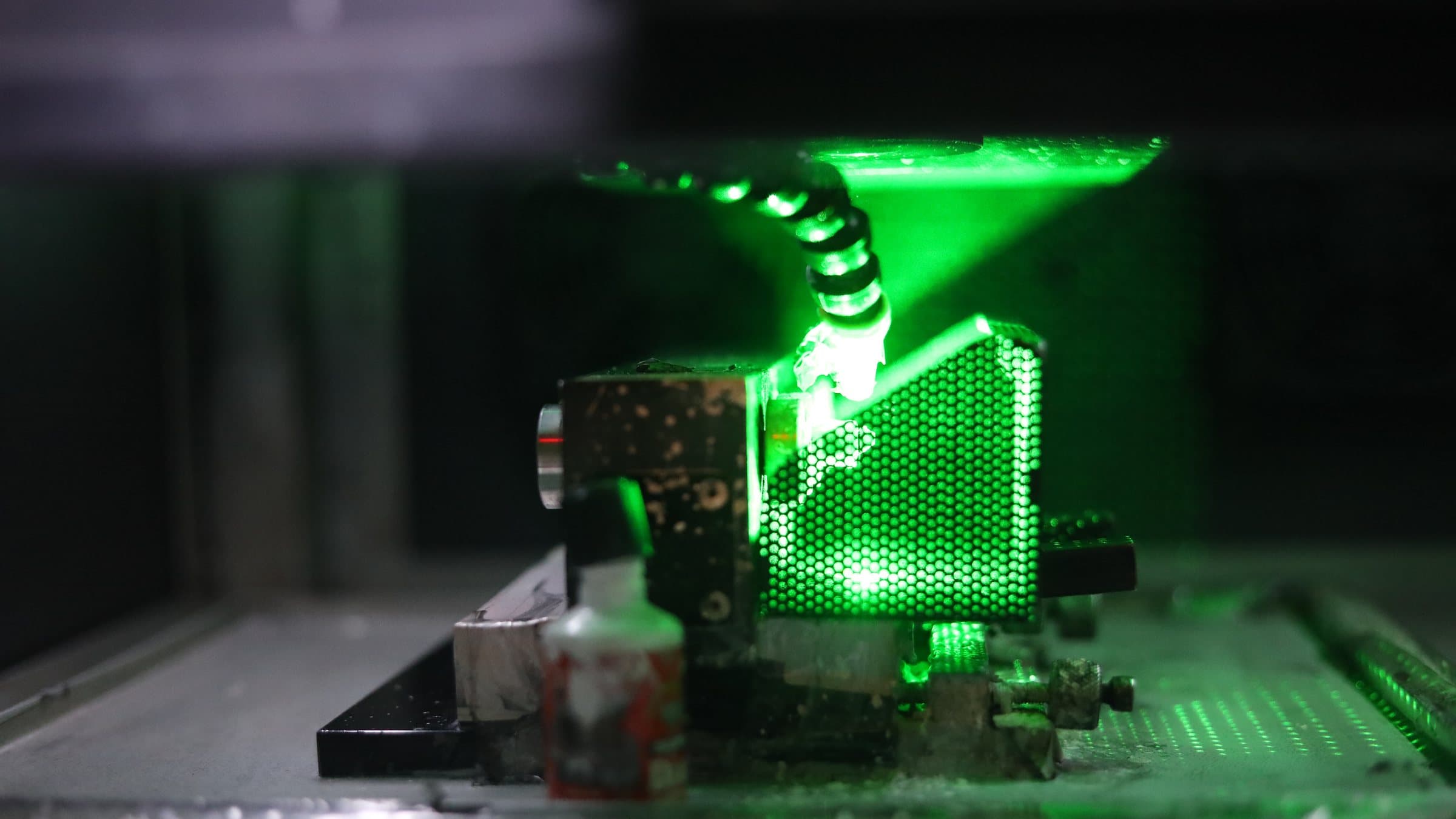 A green laser at work inside a cutting machine